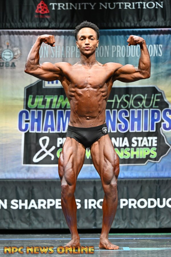 Clarence front double biceps on stage at the NPC Pennsylvania State Championships
